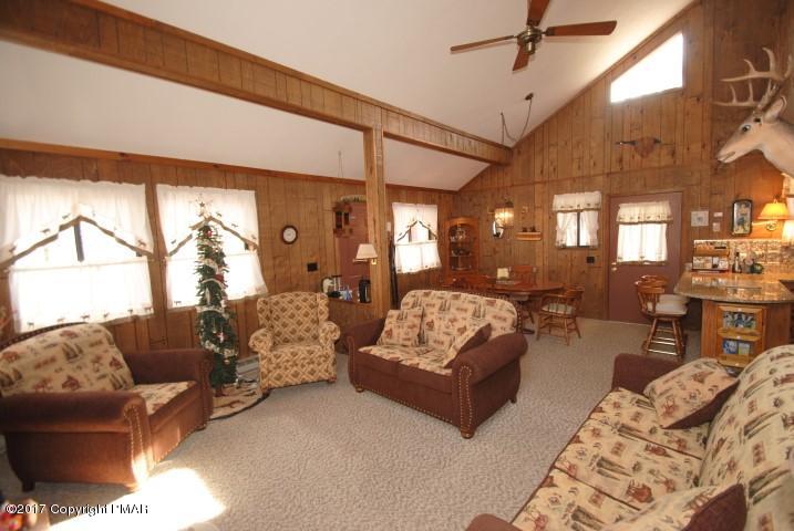 214 Elk Run Road Pocono Lake, PA 18347 - Photo 5 of 26 a living room with furniture and a large window