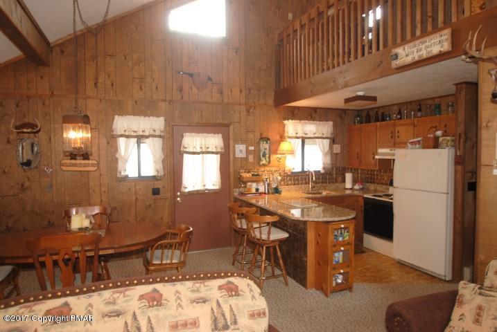 214 Elk Run Road Pocono Lake, PA 18347 - Photo 6 of 26 a room with stainless steel appliances kitchen island granite countertop furniture a counter top space and a refrigerator