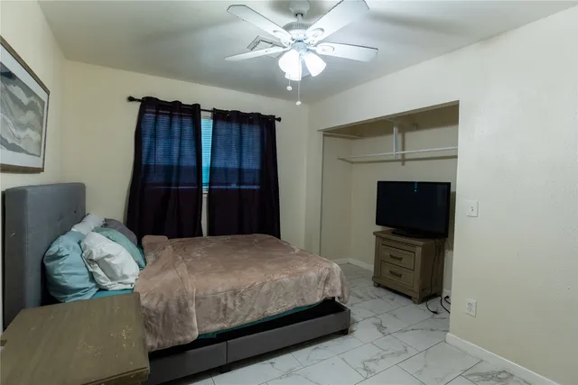 a bedroom with a bed and a television