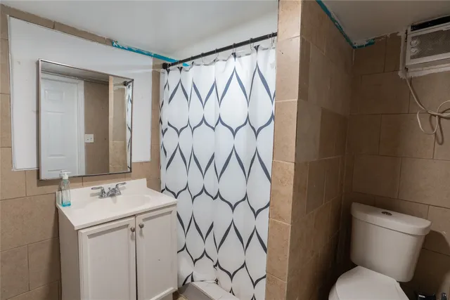 a bathroom with a sink and mirror with toilet