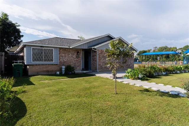 a front view of house with yard and outdoor seating