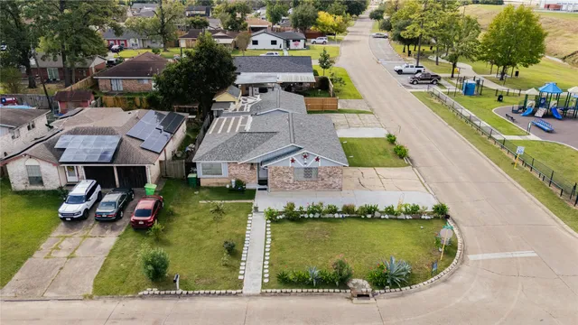 an aerial view of a house with swimming pool and ocean view