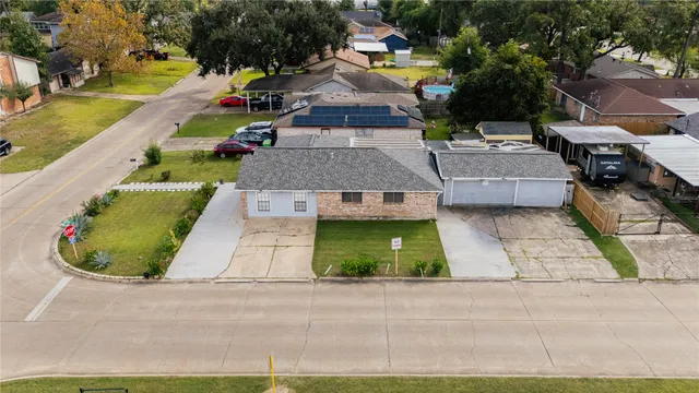 a front view of a house with a yard and potted plants