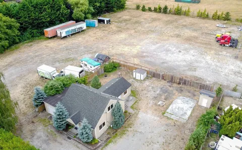 an aerial view of a house with a yard and garden