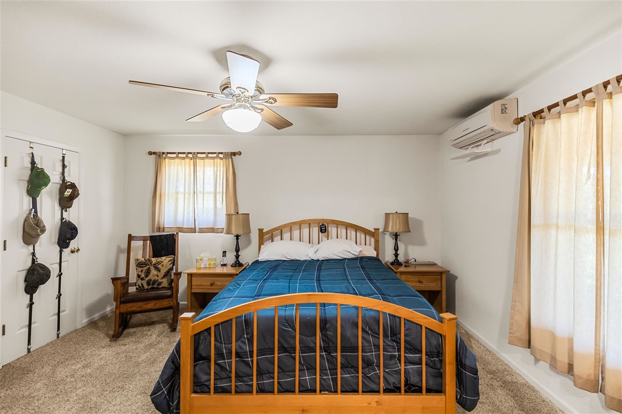 16554 Cocoran Gray Road Groveland, CA 95321 - Photo 13 of 38 Carpeted bedroom with ceiling fan and a wall mounted air conditioner