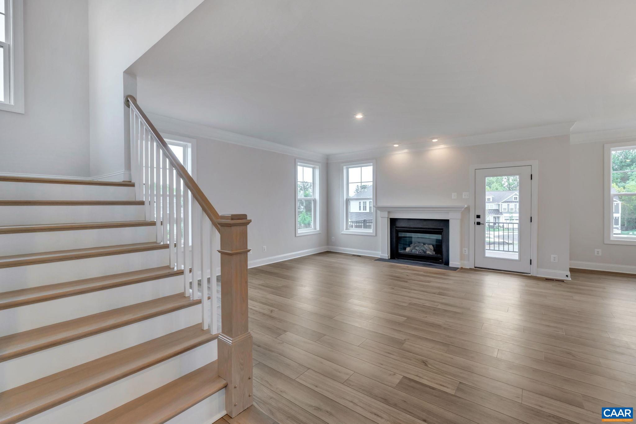 62 B Springdale Road Waynesboro, VA 22980 - Photo 11 of 56 a view of an empty room with wooden floor fireplace and a window