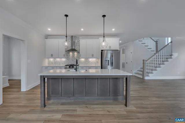 a view of a small space with wooden floor and a window