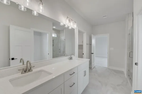 a view of a kitchen with white cabinets