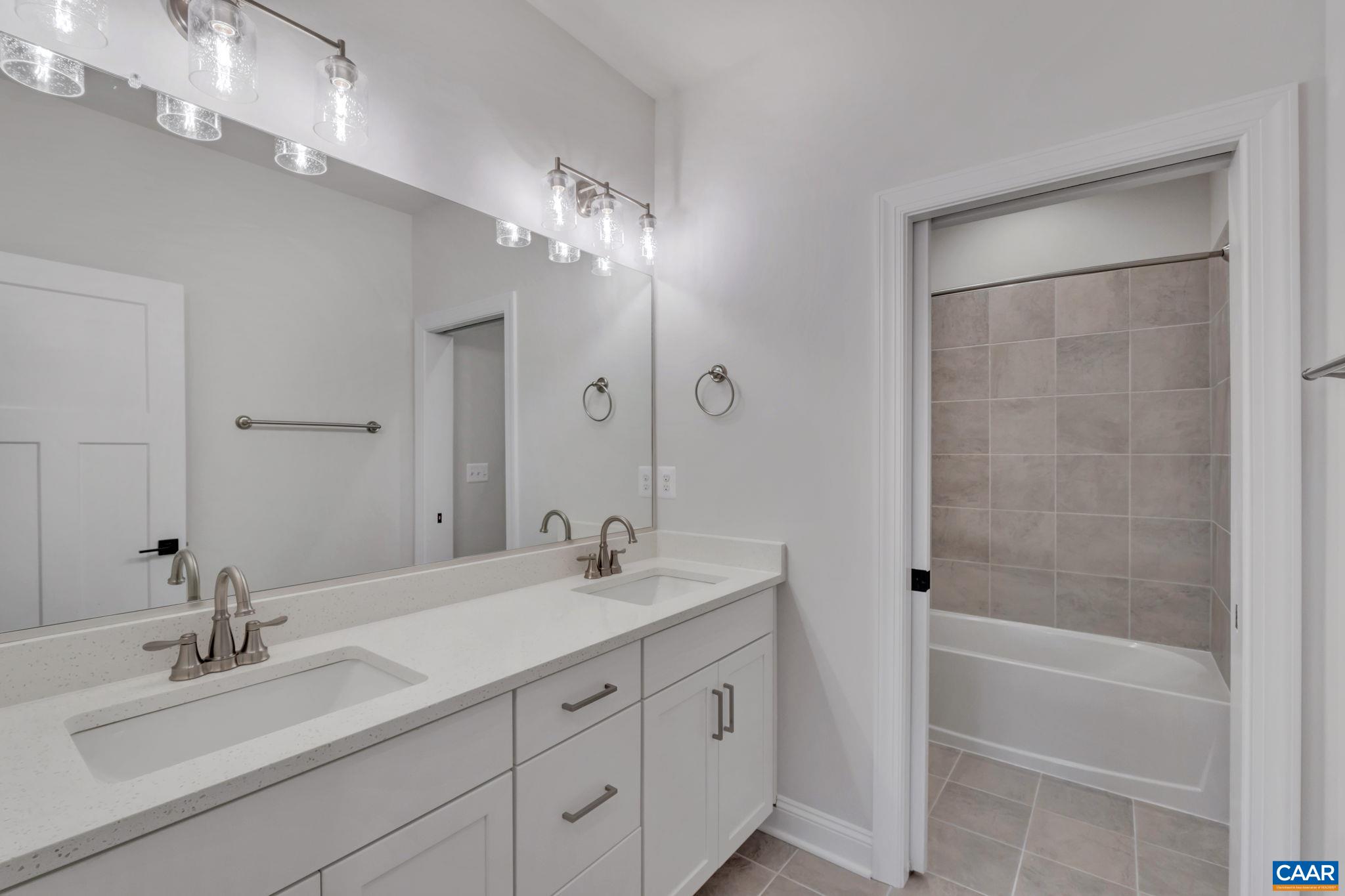 62 B Springdale Road Waynesboro, VA 22980 - Photo 37 of 56 a bathroom with a tub sink double vanity and mirror