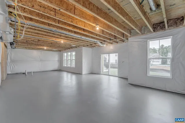 a view of staircase with a large window and wooden floor