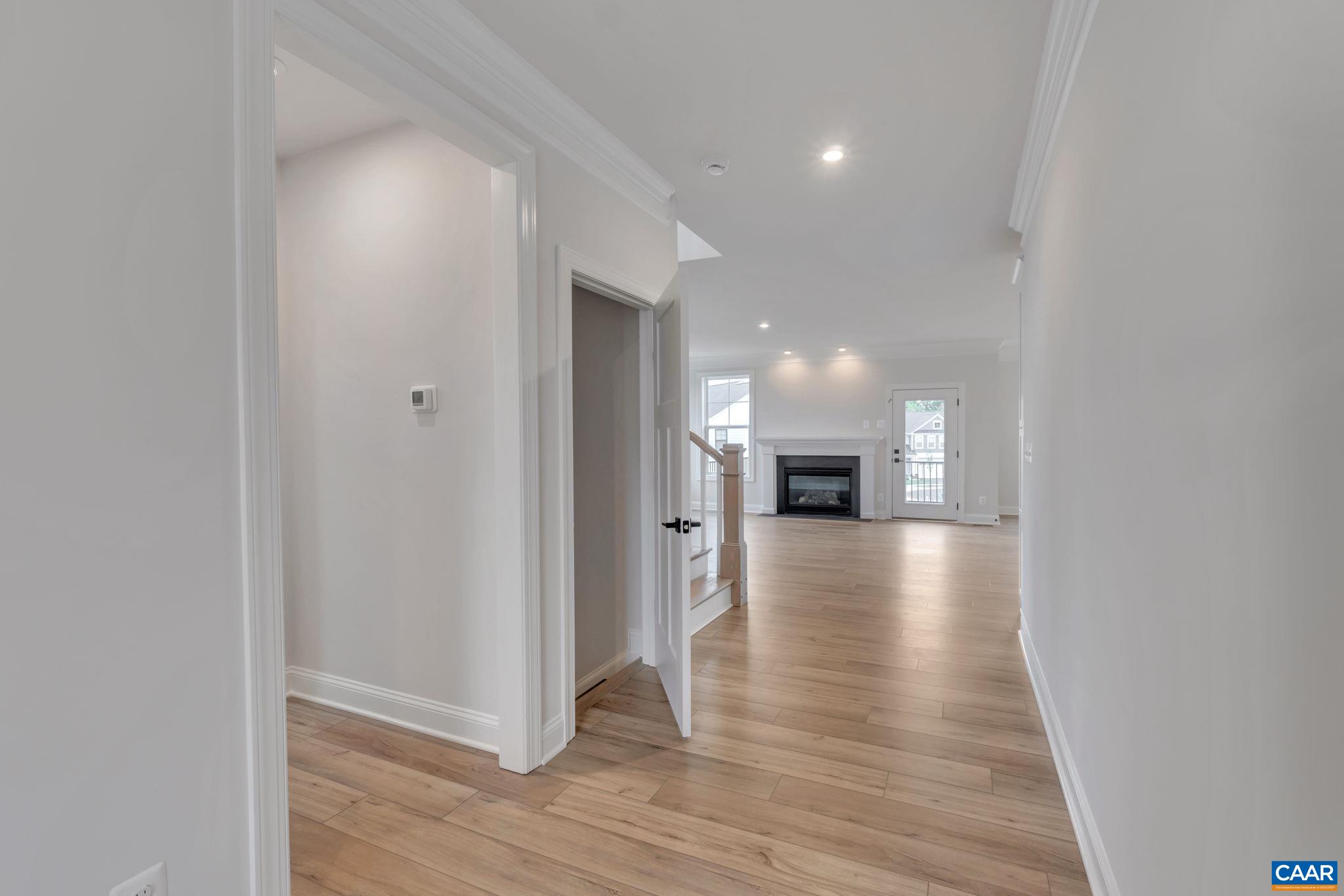 62 B Springdale Road Waynesboro, VA 22980 - Photo 9 of 56 a view of a hallway with wooden floor and a fireplace