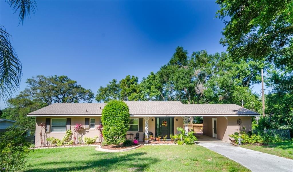 2368 Country Club Road Eustis, FL 32726 - Photo 1 of 1 a view of a house with a yard plants and large tree