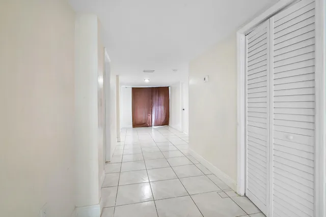 a view of an empty room with a bathroom