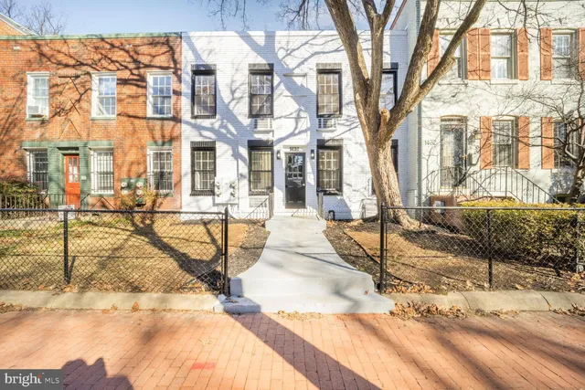 a view of a brick building with many windows