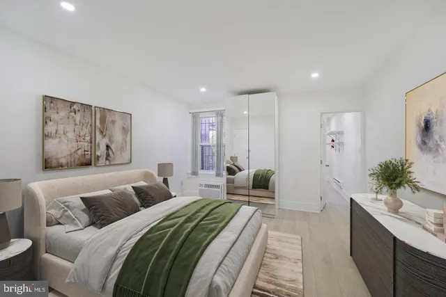 a spacious bedroom with a large bed and a couch