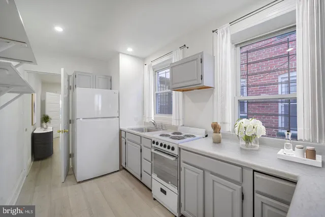 a kitchen with refrigerator and window