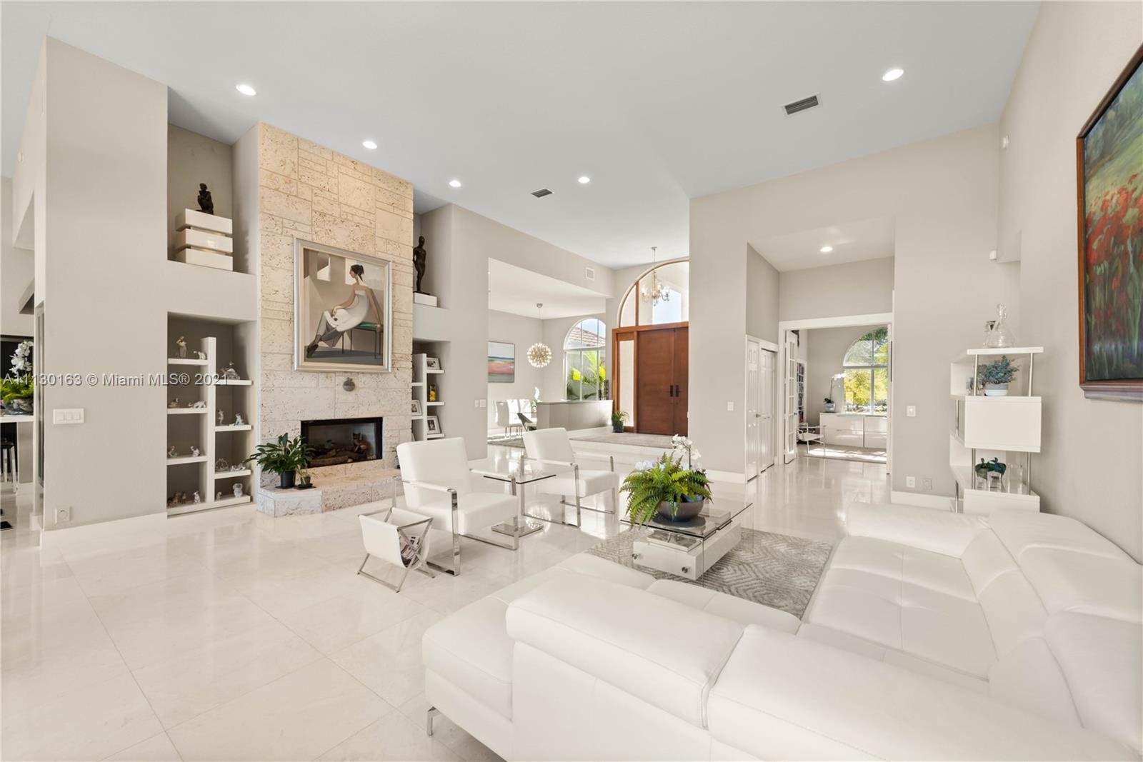 10454 Stonebridge Boulevard Boca Raton, FL 33498 - Photo 1 of 37 a living room with fireplace furniture and a large window