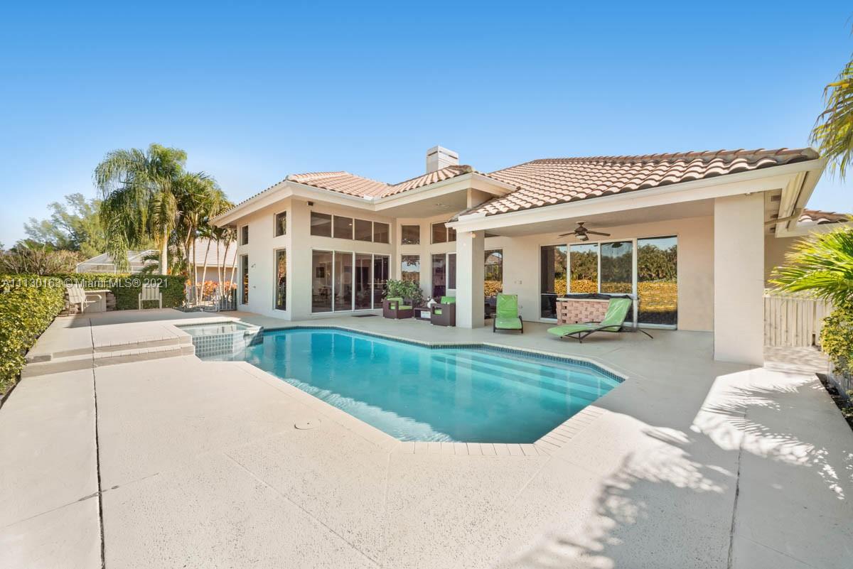10454 Stonebridge Boulevard Boca Raton, FL 33498 - Photo 3 of 37 a view of a white house with a big yard and potted plants