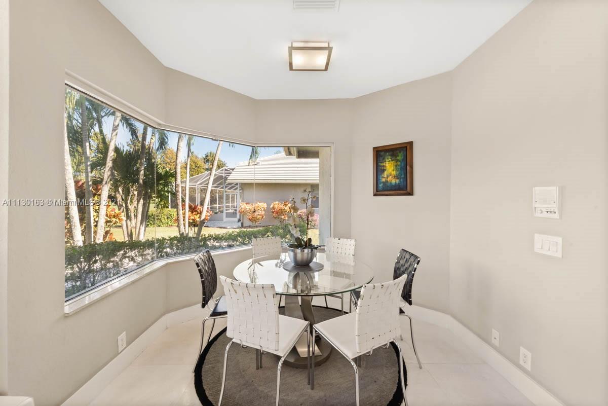 10454 Stonebridge Boulevard Boca Raton, FL 33498 - Photo 22 of 37 a dining room with furniture and window
