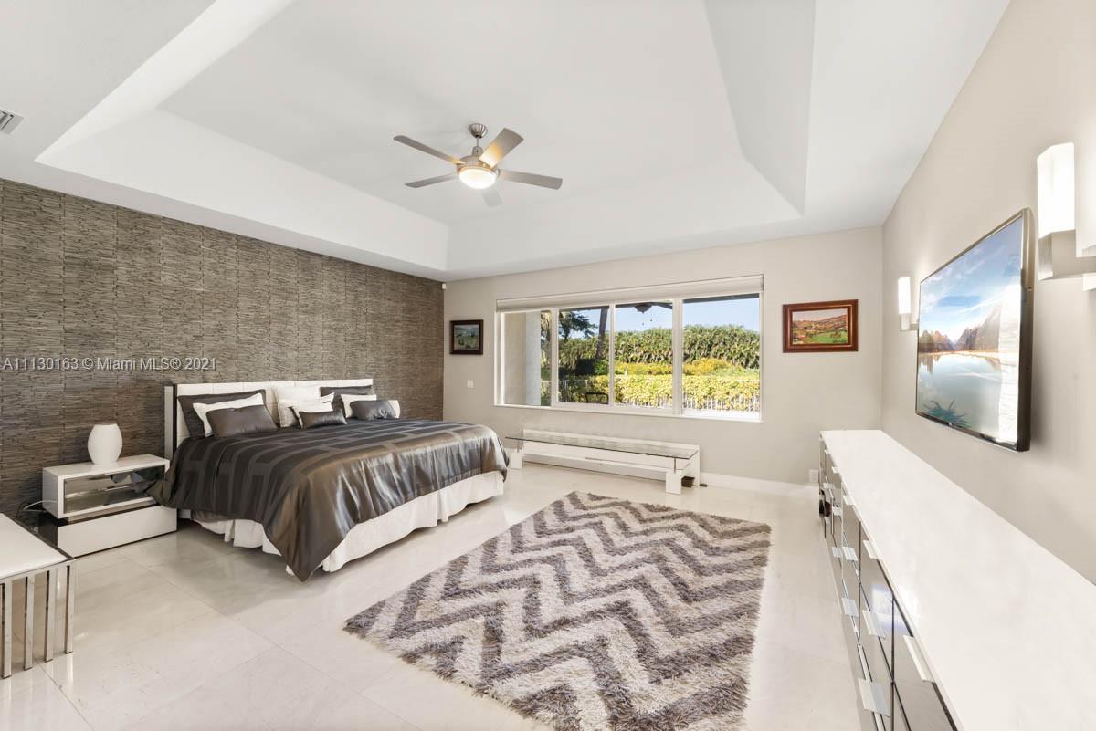10454 Stonebridge Boulevard Boca Raton, FL 33498 - Photo 23 of 37 a bedroom with double bed and a large window