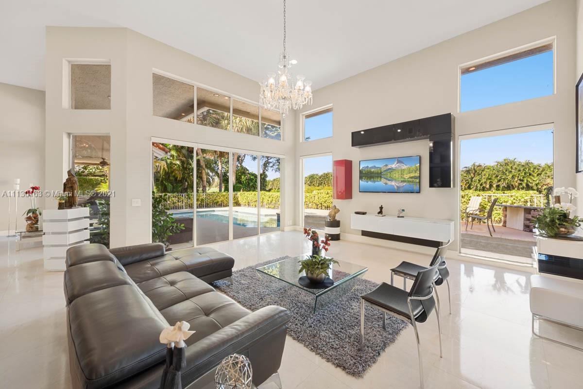 10454 Stonebridge Boulevard Boca Raton, FL 33498 - Photo 5 of 37 a living room with furniture and a chandelier