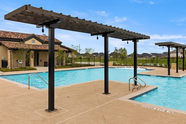 a living room with lots of wooden furniture and a chandelier