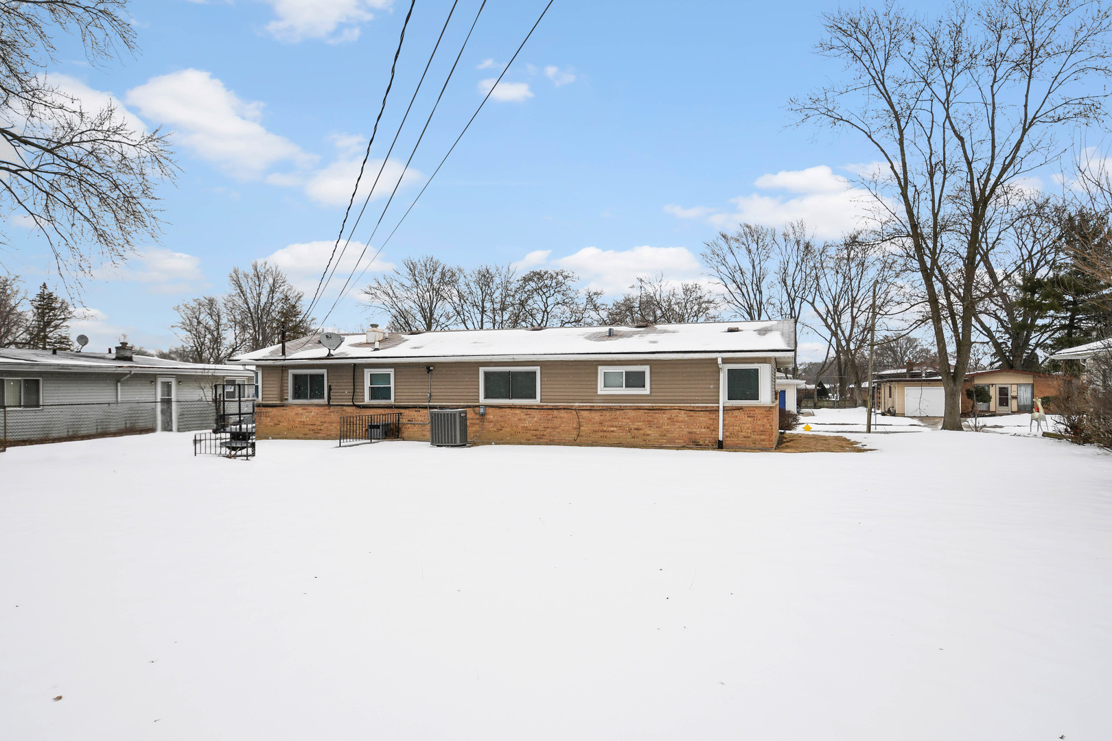 314 Windsor Street Park Forest, IL 60466 - Photo 17 of 20 a front view of a house with a yard covered with snow