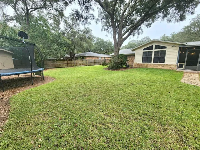 a house view with a sitting space and garden