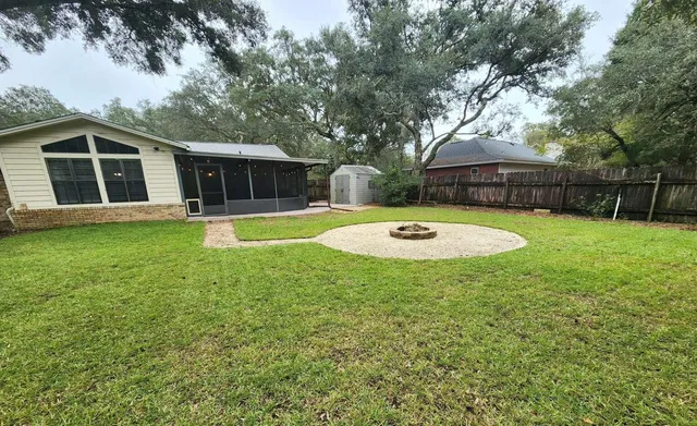 a view of a backyard with a garden and trees