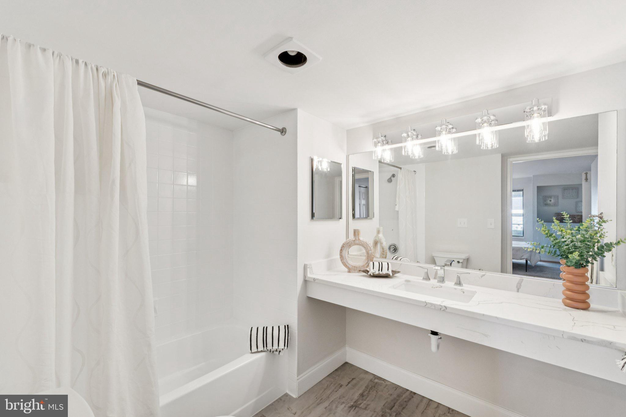 2320 Wisconsin Avenue Northwest, Unit 105 Washington, DC 20007 - Photo 16 of 24 a bathroom with a sink double vanity and a mirror