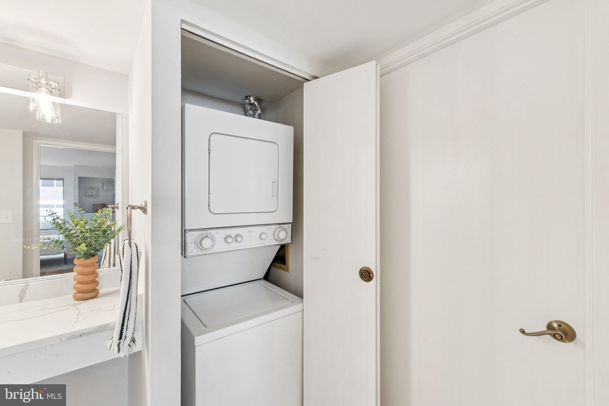 2320 Wisconsin Avenue Northwest, Unit 105 Washington, DC 20007 - Photo 17 of 24 a view of washer and dryer with bathroom in the background
