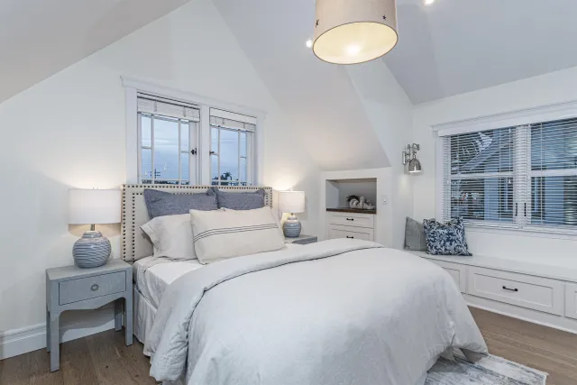 a bedroom with a bed and a large window