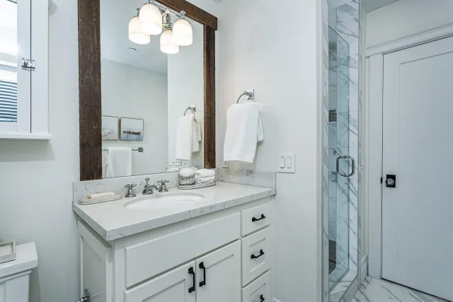 a bathroom with a sink vanity and a mirror
