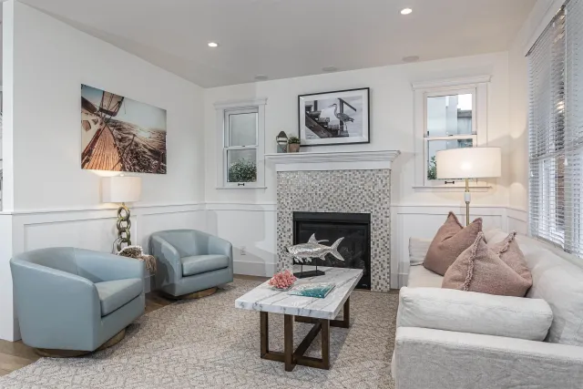 a living room with furniture and a fireplace