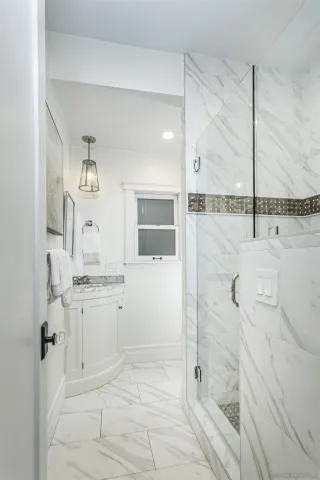 a bathroom with a shower sink and mirror