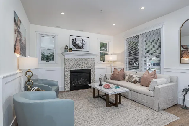 a living room with furniture and a fireplace