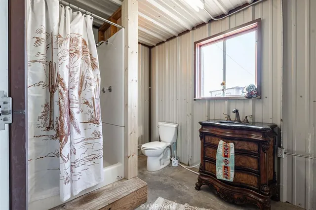 a bathroom with a toilet a sink and a window