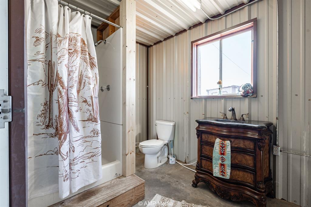 Cr Cr 450th Roscoe, TX 79545 - Photo 19 of 39 a bathroom with a toilet a sink and a window