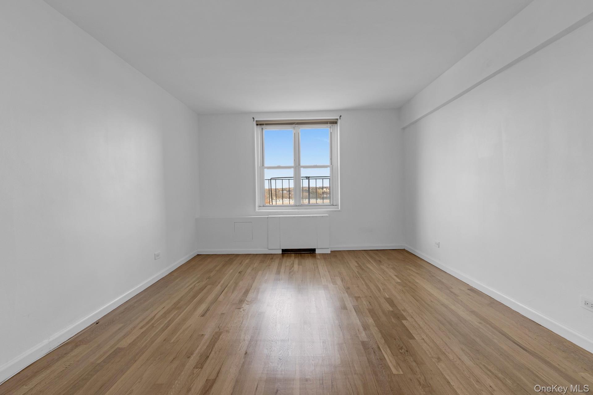 211-40 18th Avenue, Unit 6C Queens, NY 11360 - Photo 16 of 41 Unfurnished room featuring light wood-type flooring and baseboards