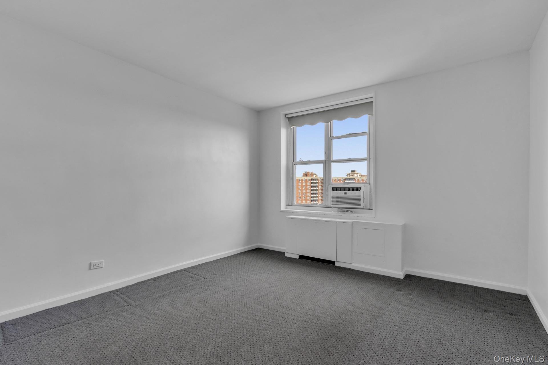 211-40 18th Avenue, Unit 6C Queens, NY 11360 - Photo 24 of 41 Carpeted spare room with baseboards and cooling unit