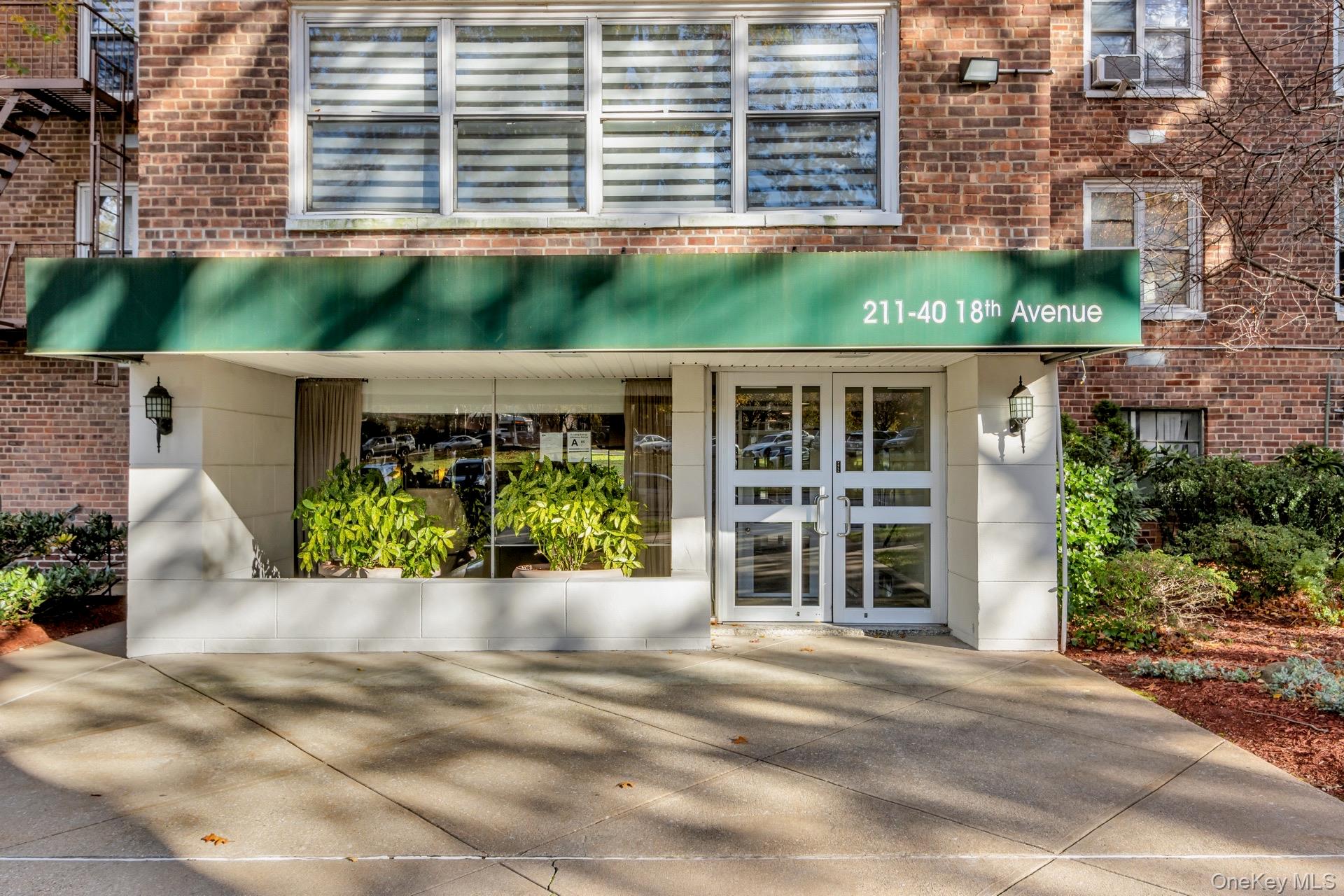 211-40 18th Avenue, Unit 6C Queens, NY 11360 - Photo 33 of 41 Property entrance with french doors and brick siding
