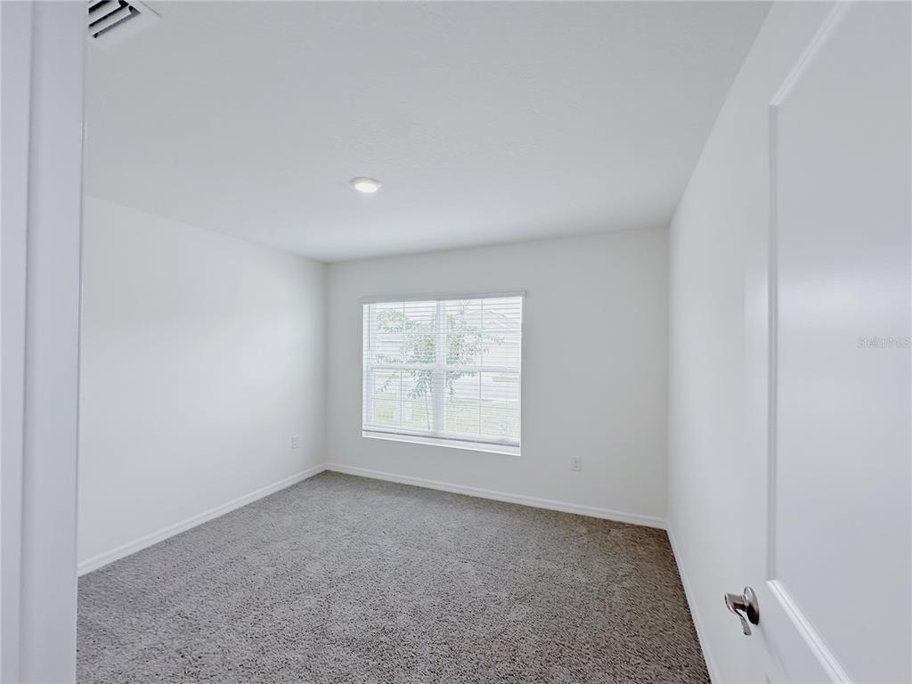 4683 Southwest 88th Lane Ocala, FL 34476 - Photo 13 of 16 an empty room with a window
