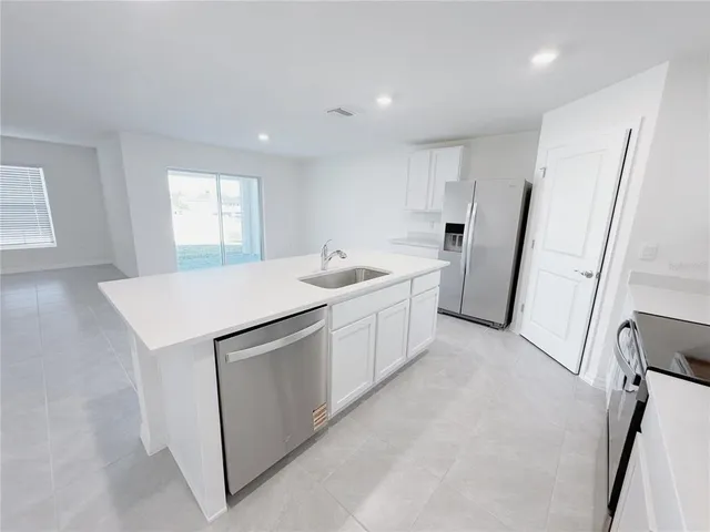 a utility room with cabinets washer and dryer