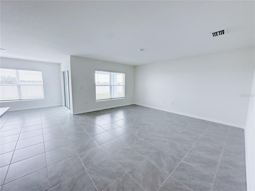 4683 Southwest 88th Lane Ocala, FL 34476 - Photo 6 of 16 wooden floor in an empty room with a window