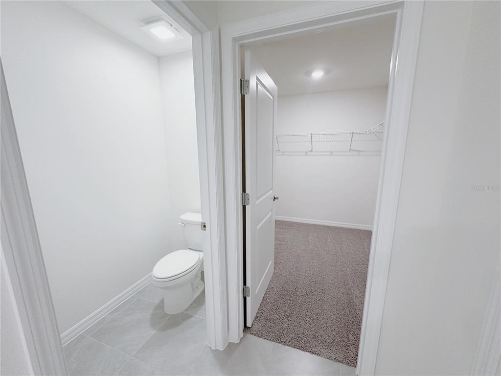 4683 Southwest 88th Lane Ocala, FL 34476 - Photo 10 of 16 a bathroom with a granite countertop sink toilet and shower