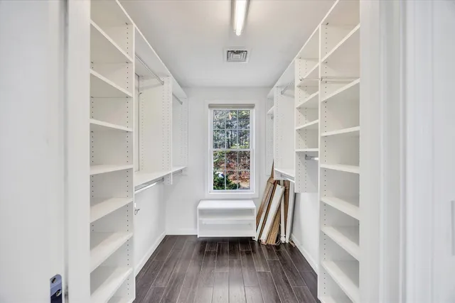 a view of walk in closet with empty racks