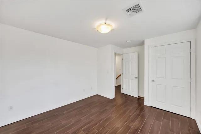 a view of an empty room and wooden floor