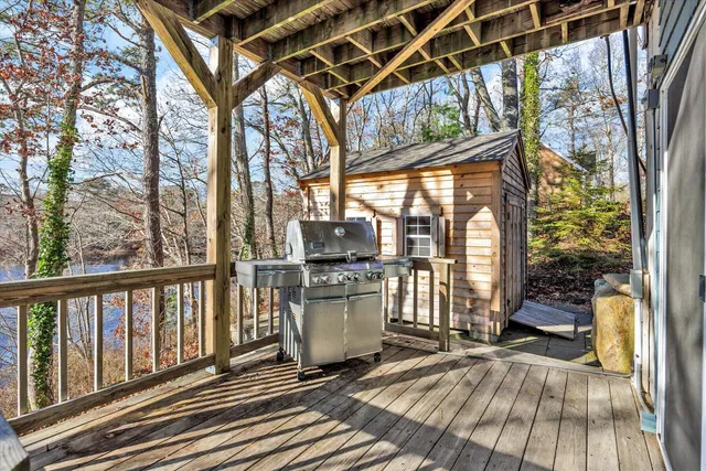 a view of a porch with wooden floor and furniture
