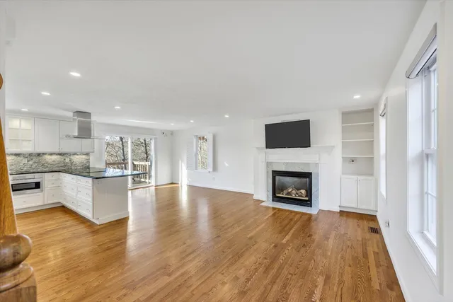 a view of kitchen with livingroom and fireplace
