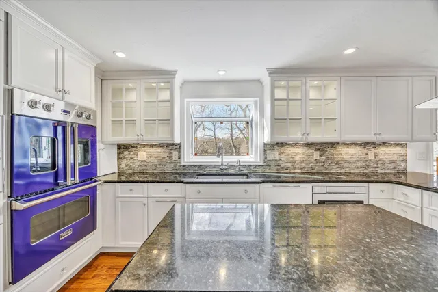 a kitchen with stainless steel appliances granite countertop a stove and a sink